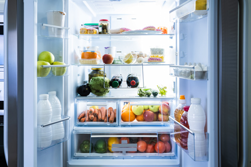 Image of a brightly-lit open fridge, well-stocked with fresh fruit and vegetables and other chilled produce found in a fridge.