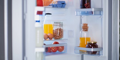 Photo of a fridge full of groceries.