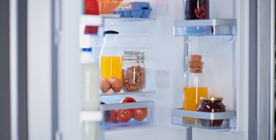 Photo of a fridge full of groceries.