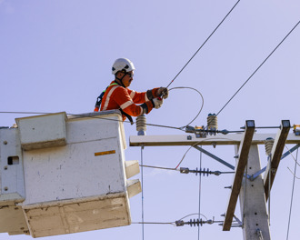 Unison crew member working on power lines 