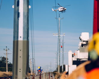 Helicopter installing power lines