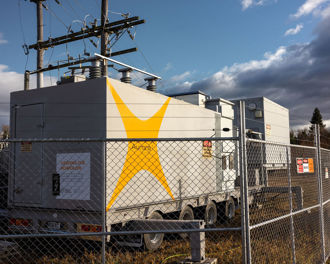 Photo shows a temporary generator with Aurora Energy branding to keep the power on at Omakau