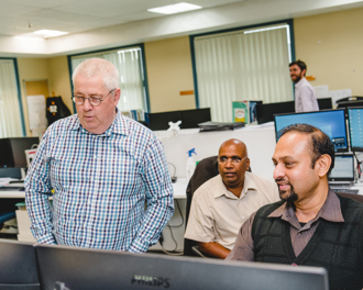 Men looking at a screen.