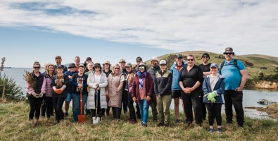Aurora Energy Planting Day, team photo holding spades and natives.