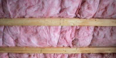 Photo at a home with open ceiling wood studs with pink insulation