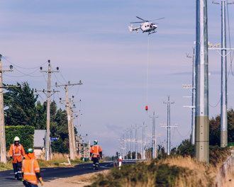 Helicopter installing power lines