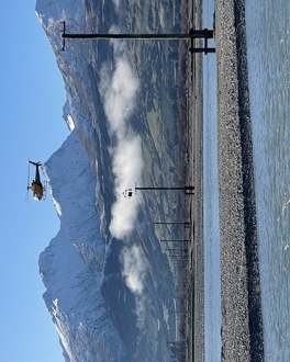 Helicopter installing power lines at Dart River
