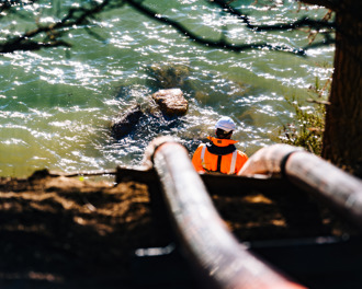 Selective focus, two submarine electricity cables heading into the Otago Harbour from land, with a worker watching on