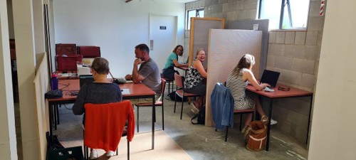 Photo of people at the community centre library working at laptops