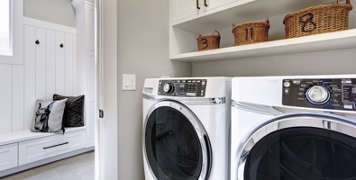 Photo of white clean laundry modern room with washer and dryer