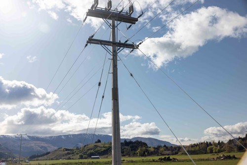 Photo of a power pole against a blue sky backdrop