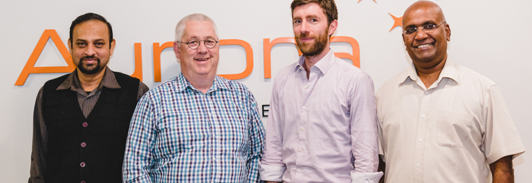 Photo of four Aurora Energy team members